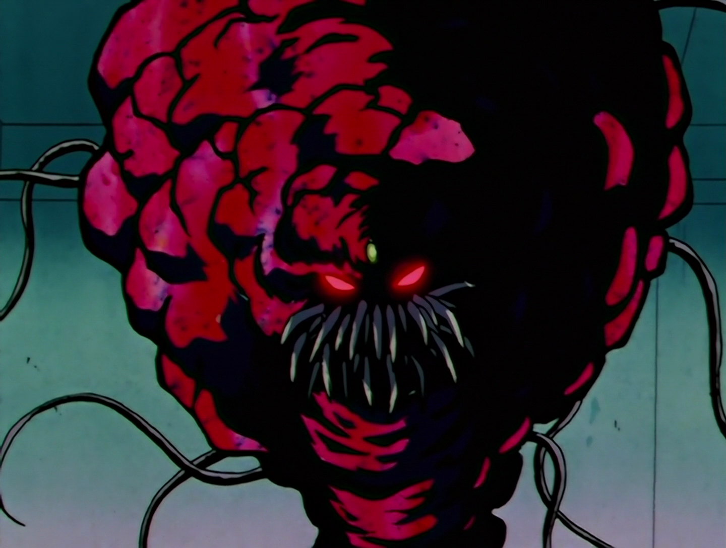 The Protodaimon, a Daimon from Sailor Moon episode 106. It’s a giant red maggot-like thing with glowing red eyes, sharp teeth and waving tentacles. It’s not pretty.